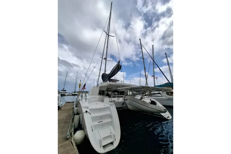  Yacht Photos Pics 2010 Lagoon 500 catamaran docked at marina under cloudy sky.