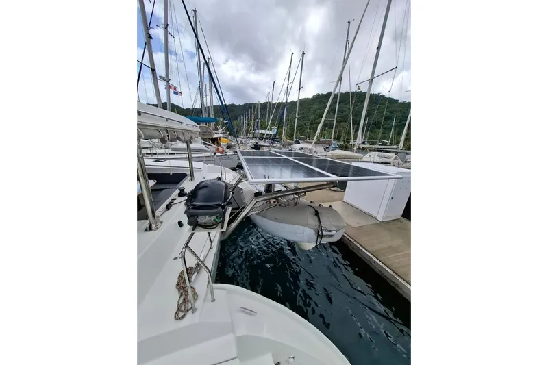  Yacht Photos Pics Lagoon 500 catamaran with solar panels and dinghy docked at marina, 2010 model.