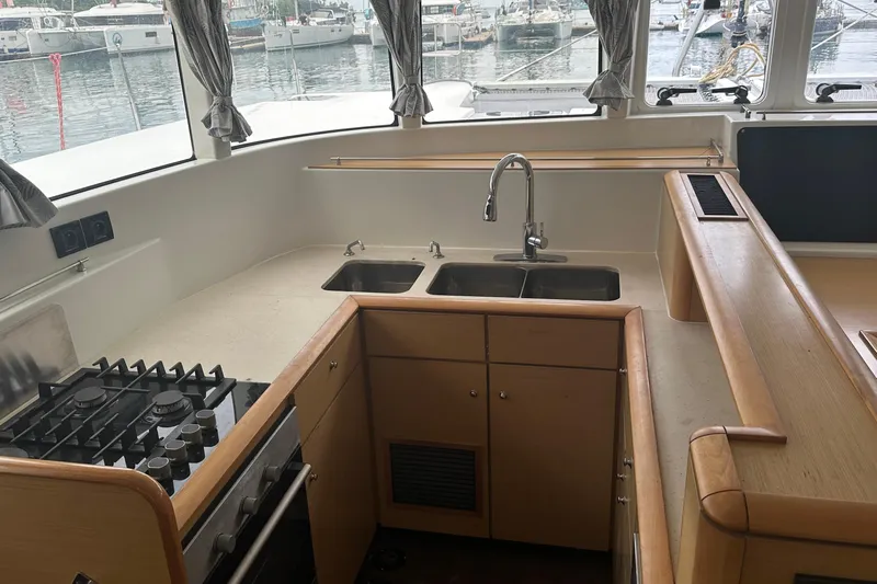  Yacht Photos Pics Modern kitchen in a 2010 Lagoon 500 yacht with stove, sink, and ample counter space.