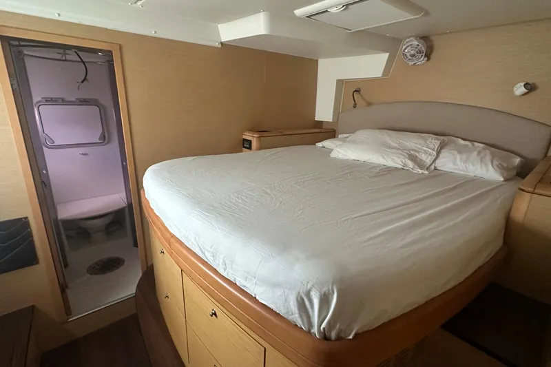  Yacht Photos Pics Luxurious cabin interior of 2010 Lagoon 500 yacht with cozy bed and ensuite bathroom.