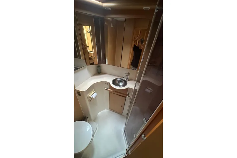  Yacht Photos Pics Bathroom interior of 2010 Lagoon 500 yacht with sink, mirror, and shower.