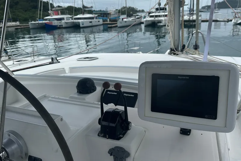  Yacht Photos Pics Cockpit view of a 2010 Lagoon 500 catamaran with navigation equipment and marina background.