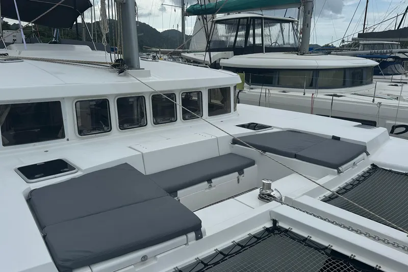  Yacht Photos Pics 2010 Lagoon 500 catamaran with cushioned seating, docked in a marina.
