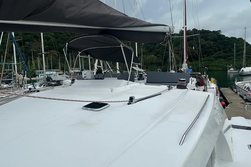  Yacht Photos Pics Lagoon 500 catamaran docked at marina, featuring spacious deck and canopy, 2010 model.