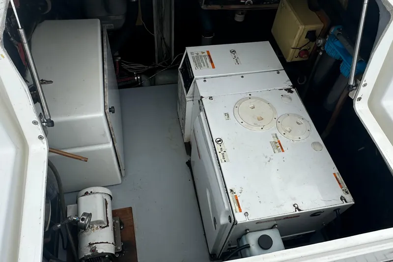  Yacht Photos Pics Engine room of a 2010 Lagoon 500 yacht, featuring mechanical equipment and storage.