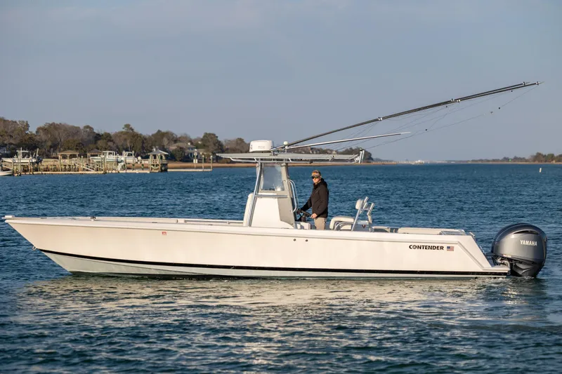  Yacht Photos Pics 2013 Contender 32 Tournament boat on water with Yamaha engine, side view.