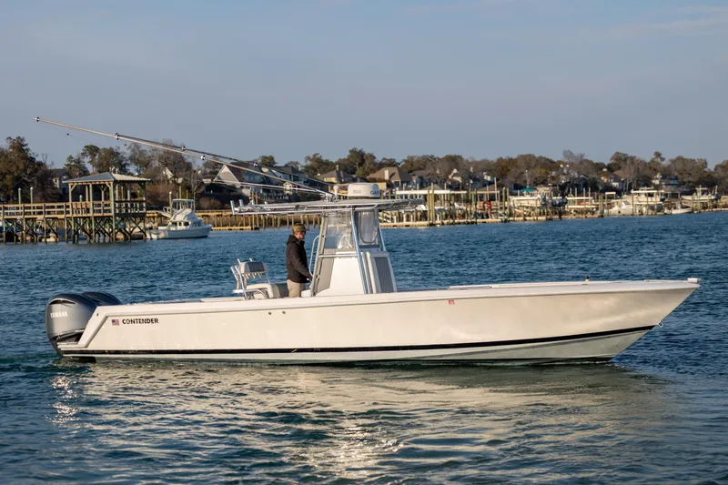  Yacht Photos Pics 2013 Contender 32 Tournament boat cruising on a calm waterway.