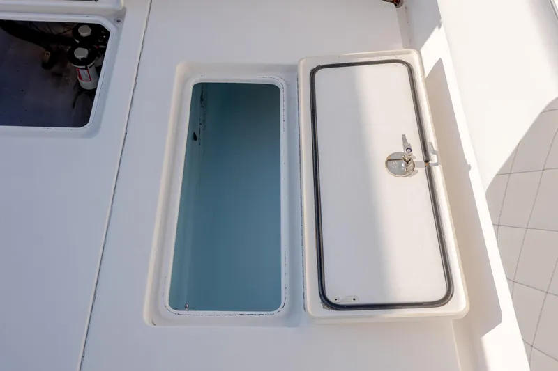  Yacht Photos Pics 2013 Contender 32 Tournament boat storage compartments with open and closed hatches.