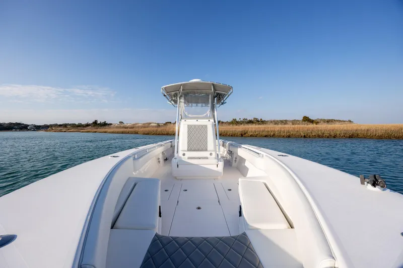  Yacht Photos Pics 2013 Contender 32 Tournament boat on calm water, clear sky background.