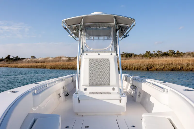  Yacht Photos Pics 2013 Contender 32 Tournament boat on calm water, featuring sleek design and spacious deck.
