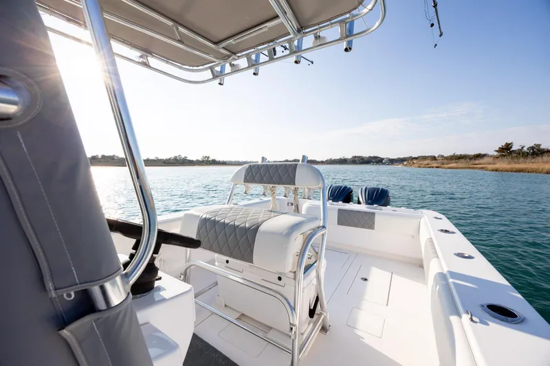  Yacht Photos Pics 2013 Contender 32 Tournament boat on calm water, featuring sleek seating and modern design.