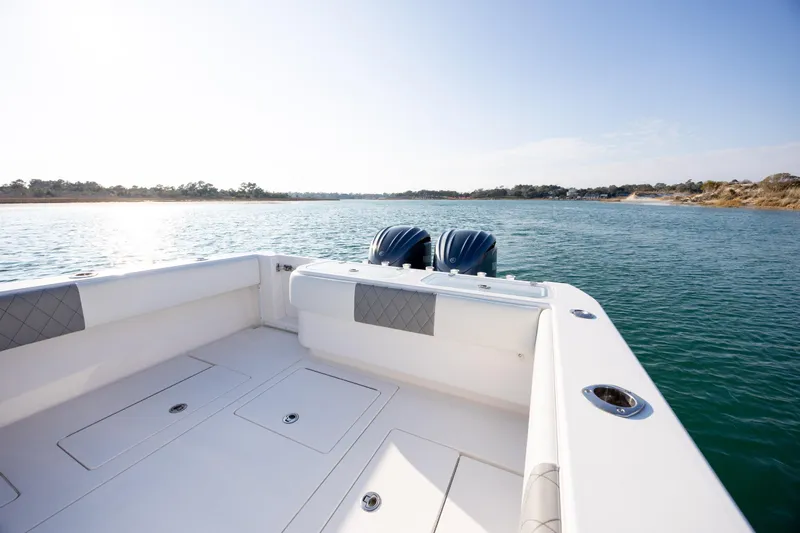  Yacht Photos Pics 2013 Contender 32 Tournament boat on calm water, featuring dual engines and spacious deck.