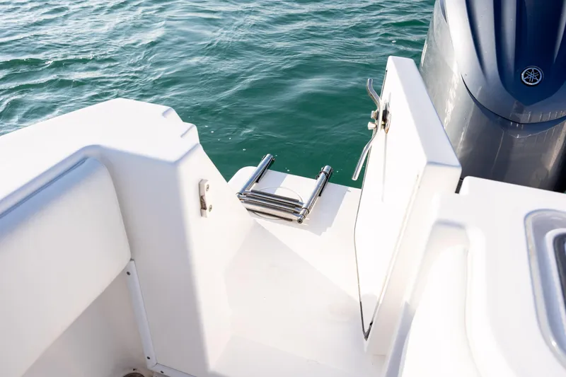  Yacht Photos Pics Contender 32 Tournament 2013 boat with swim ladder and open hatch near water.