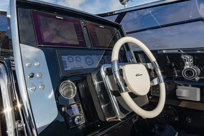 2021 Riva 56 Rivale &ldquo;grey&rdquo; Yacht Photos Pics Cockpit of 2021 Riva 56 yacht with modern navigation displays and steering wheel.