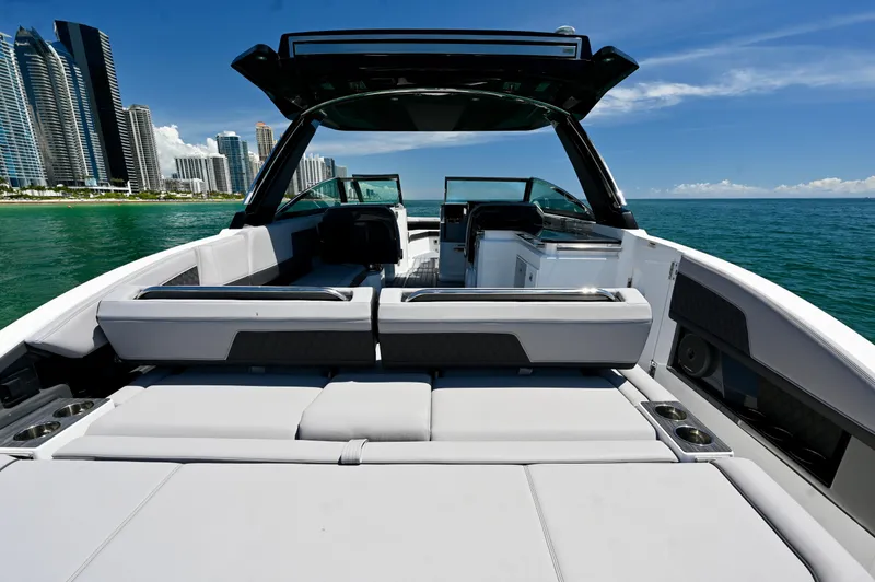  Yacht Photos Pics 2025 Cobalt R33 Outboard boat interior with city skyline and ocean view.