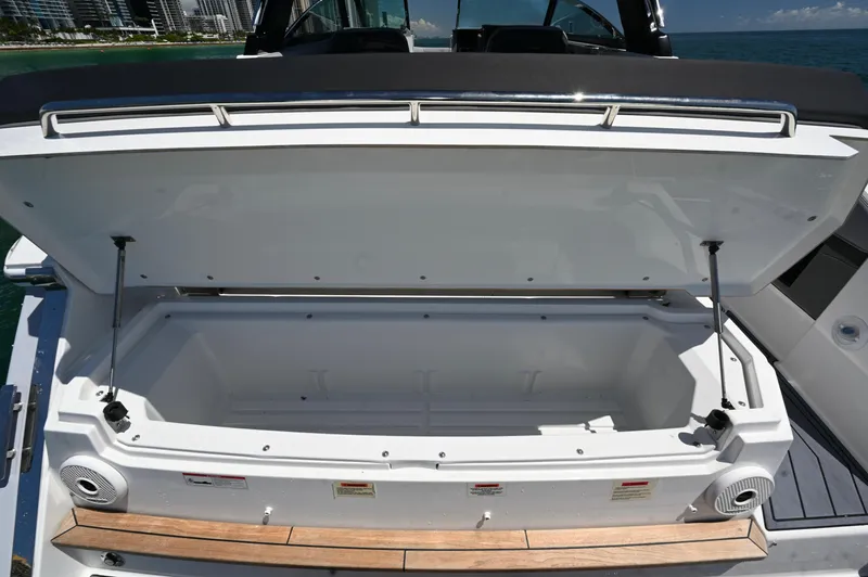  Yacht Photos Pics 2025 Cobalt R33 Outboard boat storage compartment open, showcasing spacious interior.