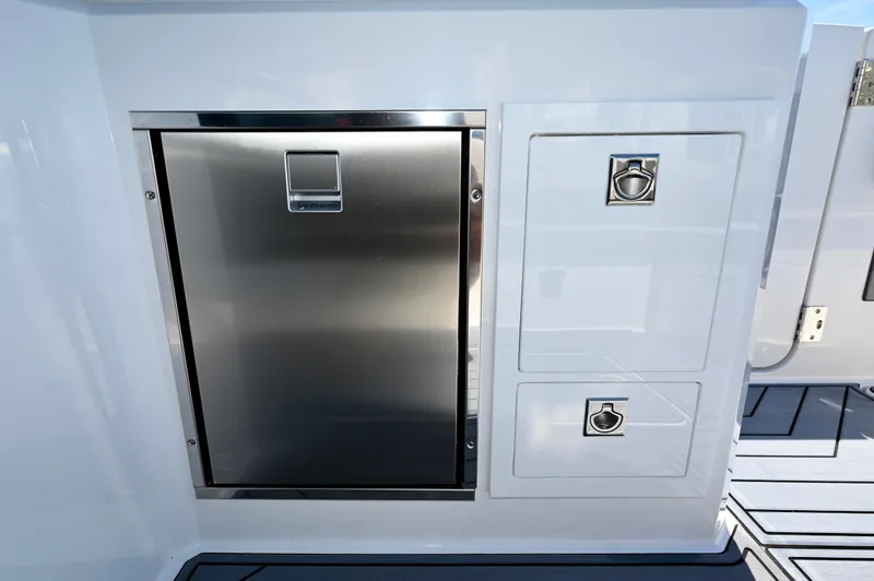  Yacht Photos Pics 2025 Cobalt R33 Outboard boat interior with stainless steel storage compartments.
