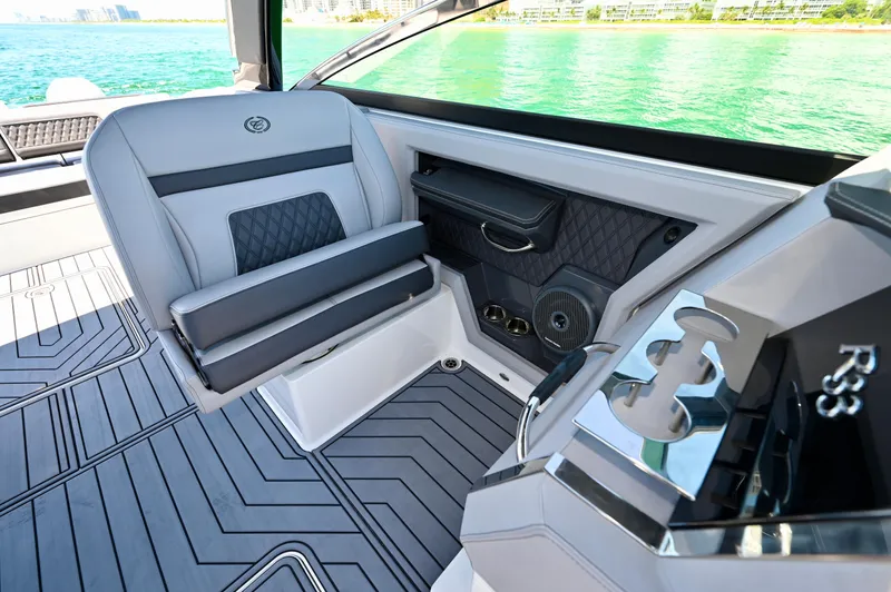  Yacht Photos Pics 2025 Cobalt R33 Outboard interior with sleek seating and modern design on a sunny day.