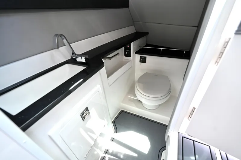  Yacht Photos Pics 2025 Cobalt R33 Outboard boat bathroom with modern sink and toilet.