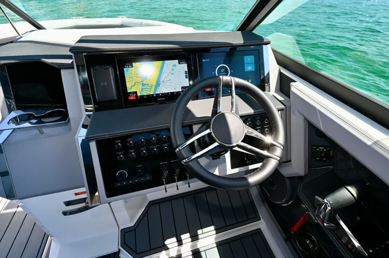  Yacht Photos Pics 2025 Cobalt R33 Outboard helm with modern navigation system and sleek steering wheel.