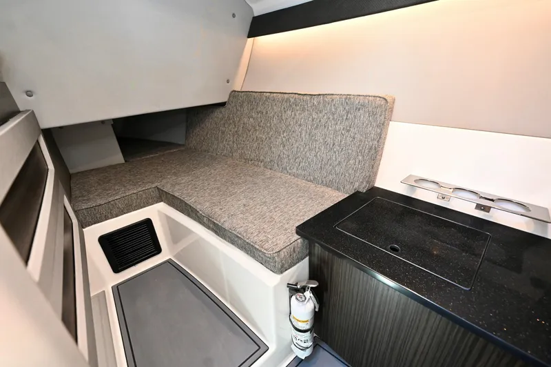  Yacht Photos Pics 2025 Cobalt R33 Outboard cabin interior with seating and kitchenette.