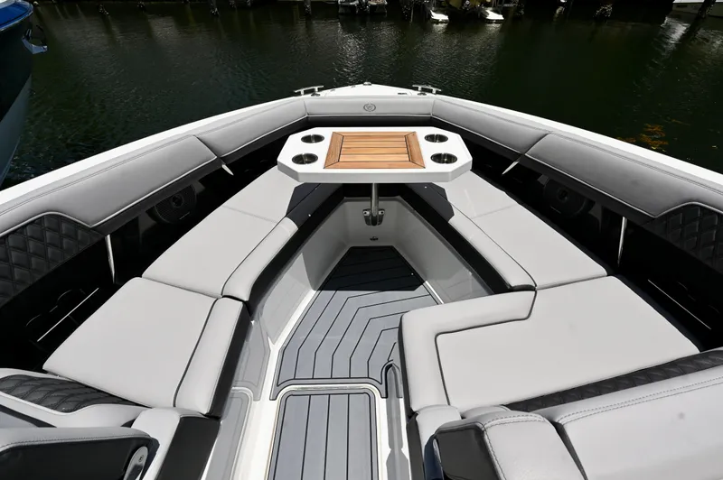  Yacht Photos Pics Luxurious seating area on 2025 Cobalt R33 Outboard boat, featuring a stylish table and cup holders.