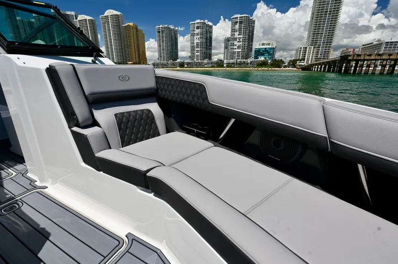  Yacht Photos Pics 2025 Cobalt R33 Outboard boat interior with luxury seating, city skyline in background.