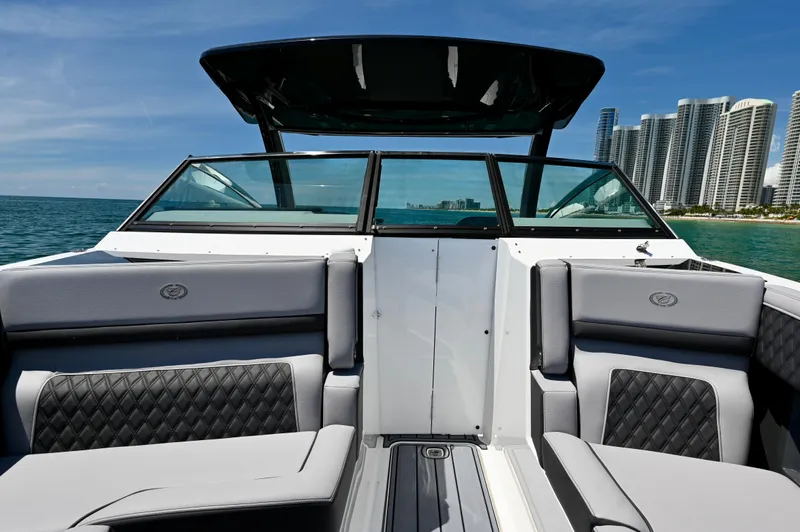  Yacht Photos Pics 2025 Cobalt R33 Outboard boat interior with ocean and city skyline view.