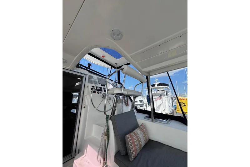  Yacht Photos Pics Interior view of 2012 Leopard 39 Owner's Version catamaran, featuring helm and seating area.