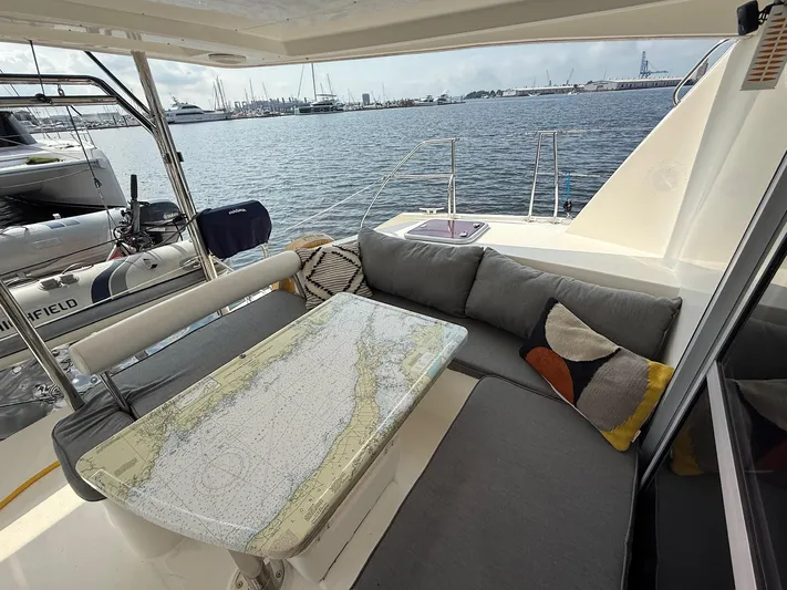  Yacht Photos Pics Cozy seating area on 2012 Leopard 39 Owner's Version yacht with nautical chart table.
