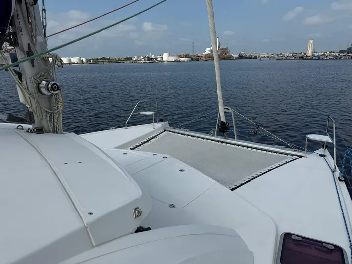  Yacht Photos Pics Leopard 39 Owner's Version catamaran on calm water, 2012 model, with cityscape in background.