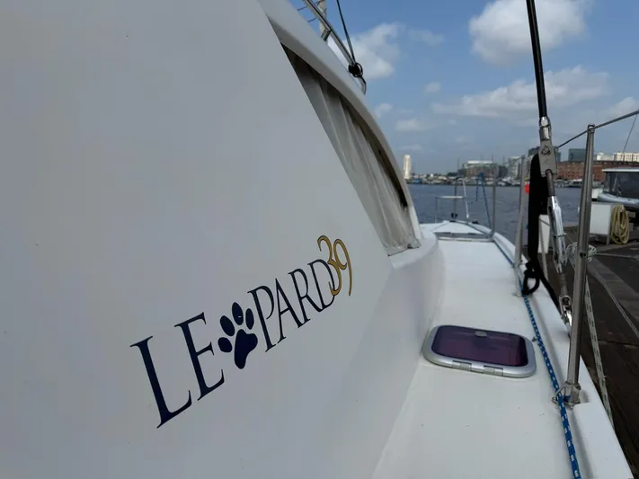  Yacht Photos Pics 2012 Leopard 39 Owner's Version catamaran docked, showcasing sleek design and branding.