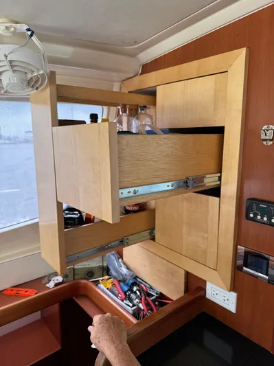  Yacht Photos Pics Interior of 2012 Leopard 39 yacht with open wooden cabinets and visible storage.