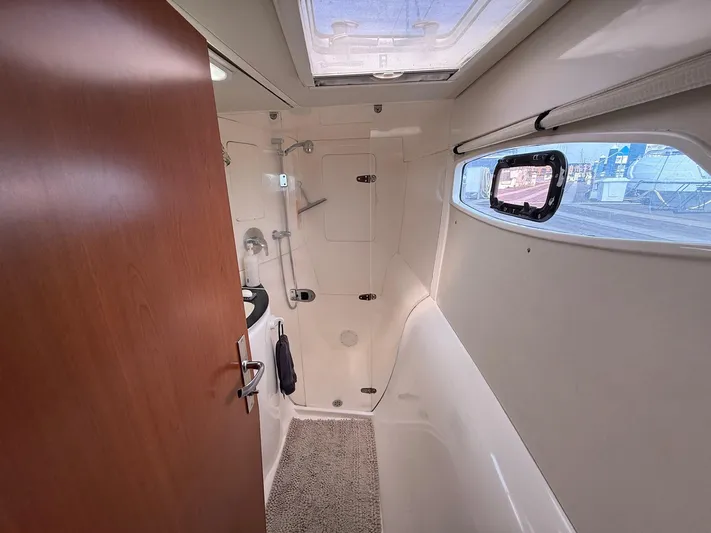  Yacht Photos Pics Bathroom interior of 2012 Leopard 39 Owner's Version yacht, featuring shower and window.