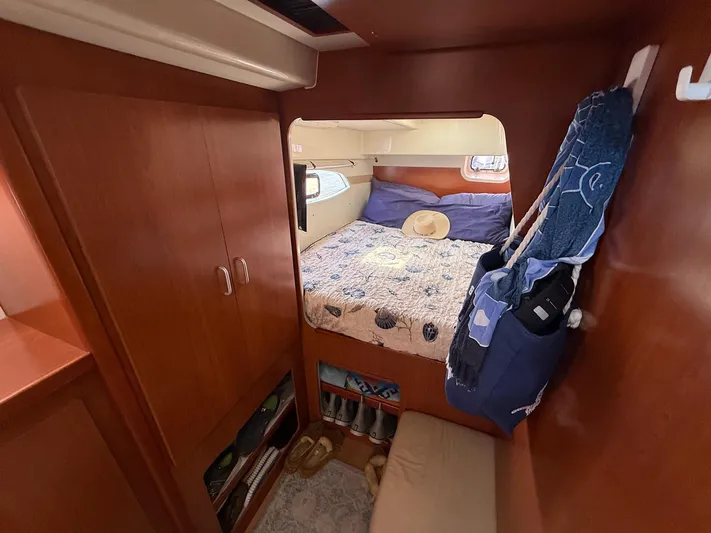  Yacht Photos Pics Cozy bedroom in 2012 Leopard 39 Owner's Version yacht with wooden cabinetry and nautical decor.