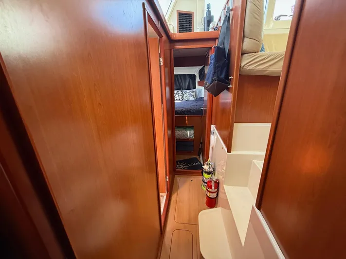  Yacht Photos Pics Interior of 2012 Leopard 39 Owner's Version yacht, featuring wooden cabinetry and cozy sleeping area.