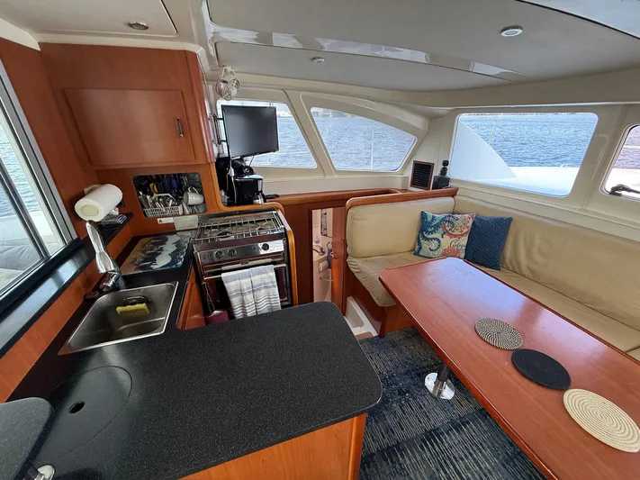  Yacht Photos Pics Interior of 2012 Leopard 39 Owner's Version yacht with kitchen and seating area.