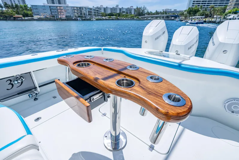  Yacht Photos Pics 2016 Yellowfin 39 Offshore boat with wooden rod holder, Mercury engines, and scenic waterfront view.