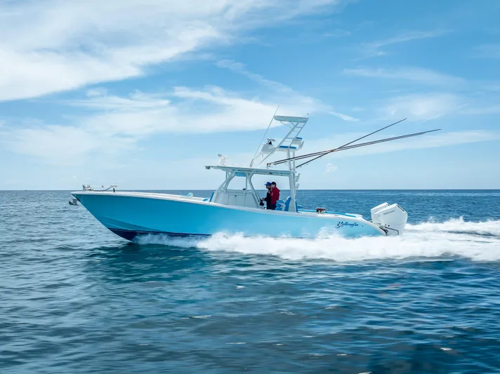  Yacht Photos Pics 2016 Yellowfin 39 Offshore boat cruising on open water under a clear blue sky.