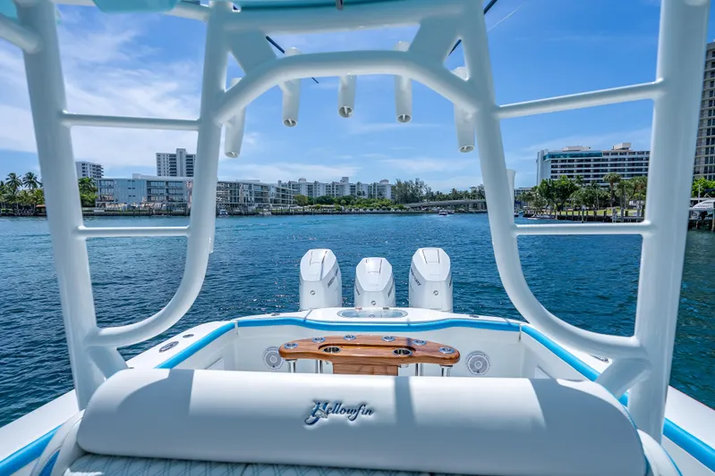  Yacht Photos Pics 2016 Yellowfin 39 Offshore boat with triple engines, scenic waterfront view, and modern cityscape backdrop.