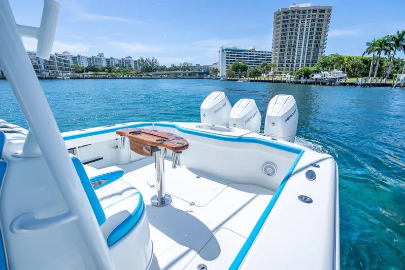  Yacht Photos Pics 2016 Yellowfin 39 Offshore boat with triple Mercury engines on a sunny waterfront.
