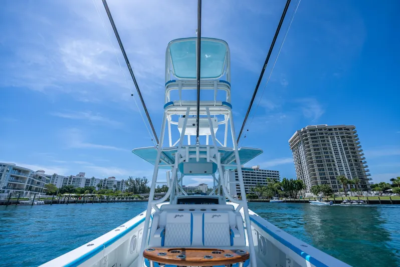  Yacht Photos Pics 2016 Yellowfin 39 Offshore boat on water, with cityscape background under clear blue sky.