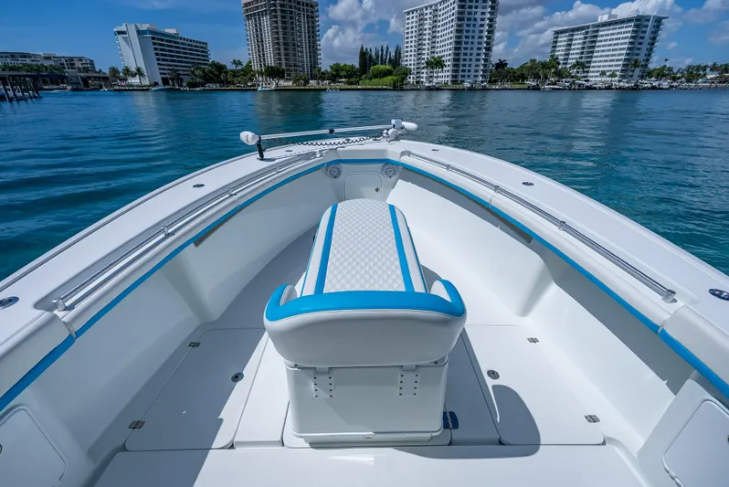  Yacht Photos Pics 2016 Yellowfin 39 Offshore boat interior with blue accents, docked near modern buildings.