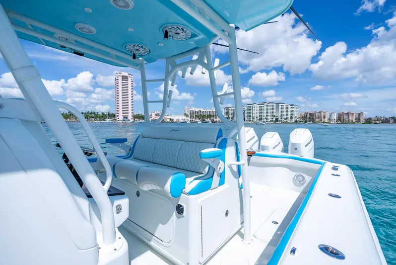  Yacht Photos Pics 2016 Yellowfin 39 Offshore boat interior with blue accents, ocean view, and city skyline.