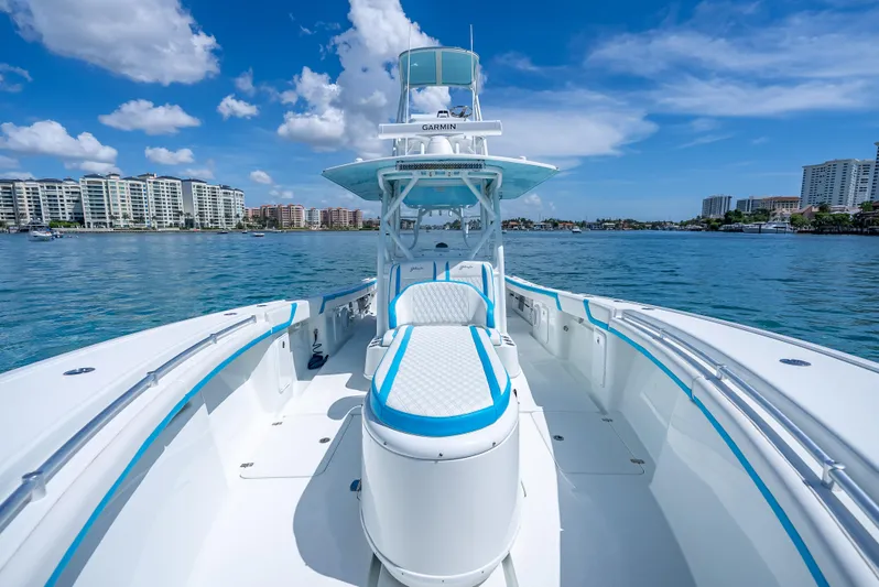  Yacht Photos Pics 2016 Yellowfin 39 Offshore boat on water, clear sky, city skyline in background.