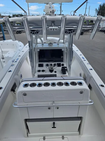 Seavee Yacht Photos Pics 2022 SeaVee 290B boat cockpit with steering console and rod holders.