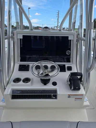 Seavee Yacht Photos Pics 2022 SeaVee 290B boat console with steering wheel and controls.