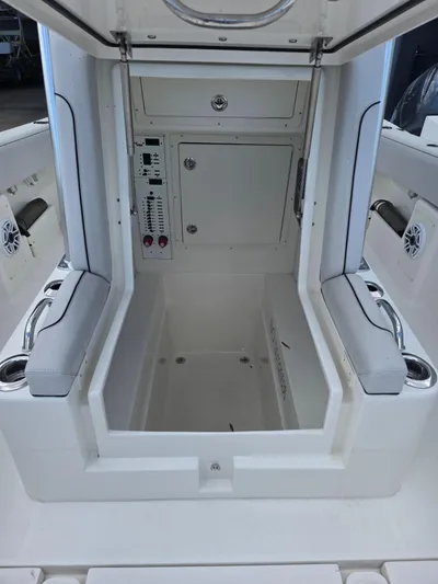 Seavee Yacht Photos Pics 2022 SeaVee 290B boat interior with storage compartment and control panel.