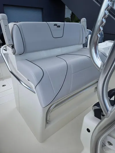 Seavee Yacht Photos Pics 2022 SeaVee 290B boat seat with sleek white upholstery and stainless steel accents.