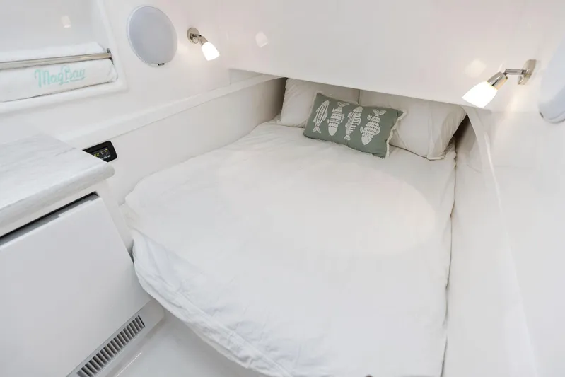  Yacht Photos Pics Cozy cabin bed in 2025 Mag Bay 43 CC boat with white bedding and seashell pillow.